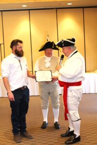 2025 2-22 GWB Luncheon -Induction of BBP Chapt. Associate Member Cody Ehlers L-R Assiate Cody Ehlers, CG Cdr R. Linscott, BBP Chapt. Pres. Donn Dalton - Photo by Wendy Hammond