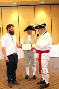 2025 2-22 GWB Luncheon -Induction of BBP Chapt. Associate Member Cody Ehlers L-R Assiate Cody Ehlers, CG Cdr R. Linscott, BBP Chapt. Pres. Donn Dalton - Photo by Wendy Hammond